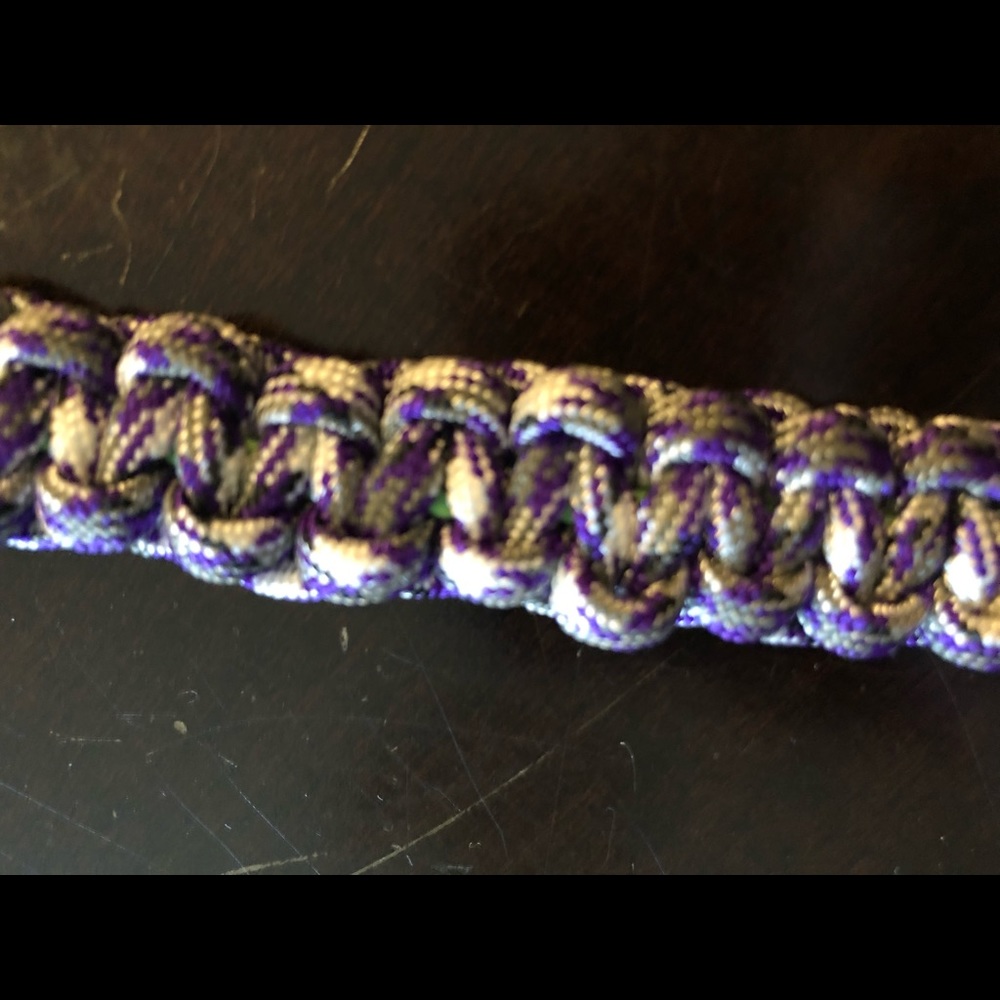 A purple, white and grey paracord keychain